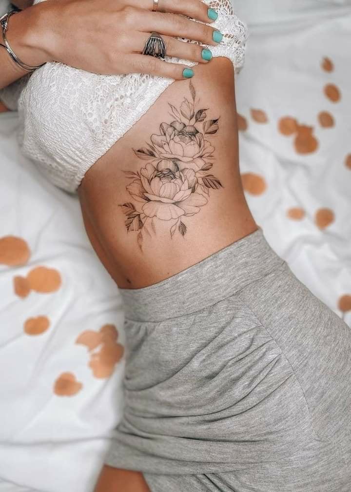 1 TOP 1 Tattoos Abdomen Outline of Black Flowers on the side below the ribs with leaves